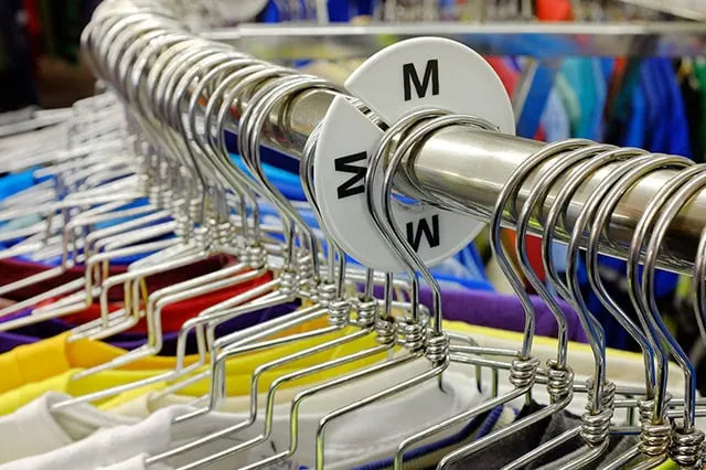 medium label on a clothes rack.
