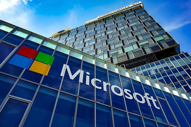 13 Best Long-Term Stocks to Buy and Hold Forever 11 the microsoft logo on the side of a glass building.