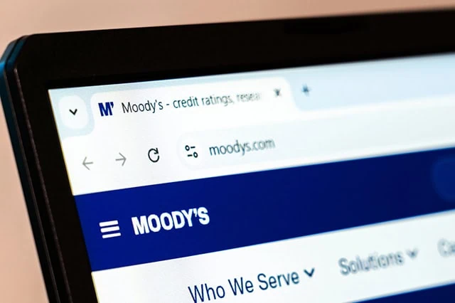 13 Best Long-Term Stocks to Buy and Hold Forever 12 picture of moodys website on a laptop screen.