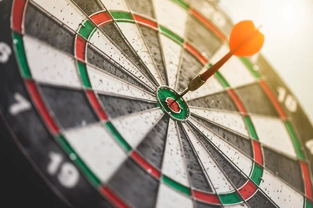 a dart hits a bullseye.